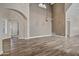 Spacious living room showcasing wood flooring and an archway to another room at 5345 E Mclellan Rd # 123, Mesa, AZ 85205