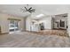 Spacious open-concept living area with connecting kitchen, ceiling fan, and access to outdoor area at 5345 E Mclellan Rd # 123, Mesa, AZ 85205