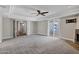 Spacious living room with carpeting, ceiling fan, and fireplace at 5345 E Mclellan Rd # 123, Mesa, AZ 85205