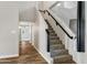 Carpeted staircase with dark railing and modern wood look flooring at 5345 E Mclellan Rd # 123, Mesa, AZ 85205