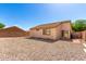 Exterior backyard featuring stone ground and small patio at 5675 S 239Th Ln, Buckeye, AZ 85326