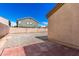 Exterior view of the backyard, featuring a stone ground and privacy wall at 5675 S 239Th Ln, Buckeye, AZ 85326