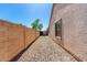 Backyard featuring a long gravel walkway and a privacy wall at 5675 S 239Th Ln, Buckeye, AZ 85326