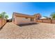 Exterior view of backyard with stone landscaping and privacy fence at 5675 S 239Th Ln, Buckeye, AZ 85326