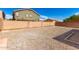 Wide angle of the backyard featuring stone ground and privacy wall at 5675 S 239Th Ln, Buckeye, AZ 85326