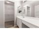 Bright bathroom with a large mirror, storage vanity, and a walk-in closet at 5675 S 239Th Ln, Buckeye, AZ 85326
