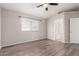 Bright bedroom features wood-look floors, neutral walls, and a ceiling fan for added comfort at 5675 S 239Th Ln, Buckeye, AZ 85326