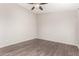 This bedroom features laminate flooring, soft neutral colors, and a ceiling fan at 5675 S 239Th Ln, Buckeye, AZ 85326