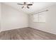 Bedroom featuring wood floors, a ceiling fan, and a bright window at 5675 S 239Th Ln, Buckeye, AZ 85326