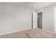 Well-lit carpeted bedroom with a ceiling fan and view to a door to an adjoining room at 5675 S 239Th Ln, Buckeye, AZ 85326