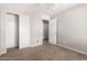 Carpeted bedroom with white trim features two closet doors, and a ceiling fan at 5675 S 239Th Ln, Buckeye, AZ 85326