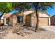 Charming single-story house with desert landscaping, mature trees, and a cozy feel at 5675 S 239Th Ln, Buckeye, AZ 85326