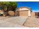 Inviting home featuring a two-car garage, desert landscaping for low upkeep, and modern exterior lighting at 5675 S 239Th Ln, Buckeye, AZ 85326