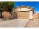 Cozy single-story home with an attached two-car garage, xeriscaping, and traditional architectural features at 5675 S 239Th Ln, Buckeye, AZ 85326