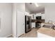 Kitchen with stainless steel appliances, white cabinets, and tan countertops at 5675 S 239Th Ln, Buckeye, AZ 85326