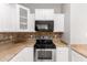 Kitchen with stainless steel oven, microwave, and stone backsplash at 5675 S 239Th Ln, Buckeye, AZ 85326