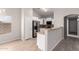 Kitchen with stainless steel appliances, white cabinets, and breakfast bar at 5675 S 239Th Ln, Buckeye, AZ 85326
