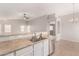 Kitchen featuring a breakfast bar with sink and dishwasher at 5675 S 239Th Ln, Buckeye, AZ 85326