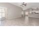 Open-concept living area with sliding glass doors, neutral paint, and open to the kitchen at 5675 S 239Th Ln, Buckeye, AZ 85326
