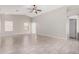 Bright living room featuring tile flooring, high ceilings, and natural light from sliding glass doors and windows at 5675 S 239Th Ln, Buckeye, AZ 85326