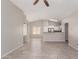 Open living room with tile flooring, ceiling fan, and view into dining area at 5675 S 239Th Ln, Buckeye, AZ 85326