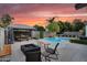 Outdoor area with a pool, gazebo, fire pit, and seating for outdoor entertaining and relaxation at 5711 E Gable Ave, Mesa, AZ 85206