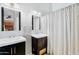 Modern bathroom with dual sinks, dark wood cabinets, and bright lighting at 5711 E Gable Ave, Mesa, AZ 85206