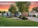 Inviting single-story home with lush green lawn, mature trees, and charming curb appeal at 5711 E Gable Ave, Mesa, AZ 85206