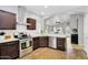 Well-equipped kitchen with stainless steel appliances, wood cabinets, and a breakfast bar at 5711 E Gable Ave, Mesa, AZ 85206