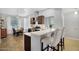 Open concept kitchen with stainless appliances, counter seating, and a view to the dining area at 5711 E Gable Ave, Mesa, AZ 85206