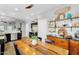 Spacious eat-in kitchen featuring a large wooden table, stainless steel appliances, and modern decor at 5711 E Gable Ave, Mesa, AZ 85206