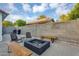 Spacious outdoor patio featuring a built-in fire pit, comfortable seating, grill, and privacy wall at 5711 E Gable Ave, Mesa, AZ 85206
