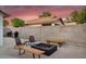 Cozy patio featuring a fire pit, seating, grill, and a privacy wall for outdoor relaxation and entertainment at 5711 E Gable Ave, Mesa, AZ 85206
