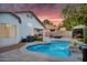 Resort-style backyard with sparkling pool, covered patio, outdoor kitchen, and lush landscaping at 5711 E Gable Ave, Mesa, AZ 85206