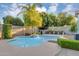 Lush backyard features a sparkling pool, palm trees, and ample patio space for outdoor entertaining at 5711 E Gable Ave, Mesa, AZ 85206