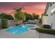 Backyard oasis with a sparkling pool, waterfall feature, mature trees, and a serene atmosphere at 5711 E Gable Ave, Mesa, AZ 85206
