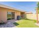 Artificial turf backyard with shaded patio, shade sail, and access to the home at 602 E Colgate Dr, Tempe, AZ 85283