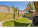 Artificial turf backyard features low maintenance landscape and a shade sail at 602 E Colgate Dr, Tempe, AZ 85283