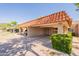 Exterior view featuring a covered carport with a terra cotta roof, tidy landscaping, and an inviting entrance at 602 E Colgate Dr, Tempe, AZ 85283
