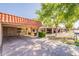 Charming home exterior featuring a spacious carport, vibrant green trees, and a well-maintained lawn at 602 E Colgate Dr, Tempe, AZ 85283