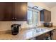 Kitchen showcases a stainless steel sink, granite countertops, and dark wood cabinets at 602 E Colgate Dr, Tempe, AZ 85283
