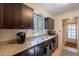 Granite countertops and dark wood cabinets in a bright, functional kitchen at 602 E Colgate Dr, Tempe, AZ 85283