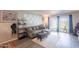 Bright living room featuring hardwood floors, modern furnishings, and sliding glass doors to the backyard at 602 E Colgate Dr, Tempe, AZ 85283