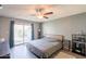 This cozy bedroom offers a slider to the backyard, a ceiling fan, and neutral walls at 602 E Colgate Dr, Tempe, AZ 85283