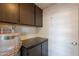 The utility room boasts matching cabinets and a new AO Smith water heater at 602 E Colgate Dr, Tempe, AZ 85283