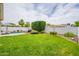 Spacious backyard with lush green grass, a pool, and a well-manicured hedge at 605 W Sandra Terrace Ter, Phoenix, AZ 85023