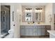 Beautiful bathroom features a dual sink vanity, decorative tile backsplash, and a glass-enclosed shower at 605 W Sandra Terrace Ter, Phoenix, AZ 85023