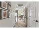 Bright hallway featuring hard flooring, gallery wall, and glimpses of the dining room at 605 W Sandra Terrace Ter, Phoenix, AZ 85023