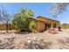 Charming backyard features a patio with chairs, gravel landscaping, and lush greenery at 7003 S 23Rd Ln, Phoenix, AZ 85041