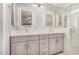 Elegant bathroom with double sink, LED mirrors, quartz countertops, and walk-in shower at 7003 S 23Rd Ln, Phoenix, AZ 85041